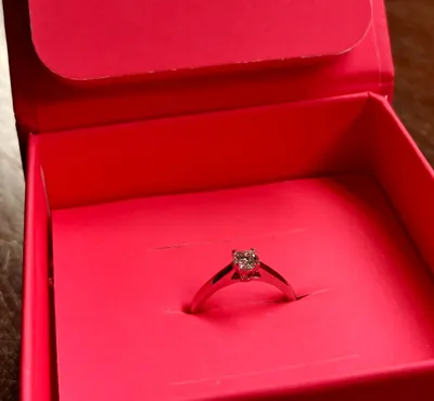 A photograph of the ARYAMOND box, open, with a solitaire ring in it
