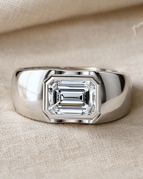The Frame Solitaire Ring on pale ivory silk