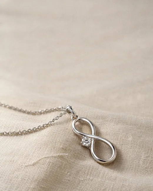 The Infinity Solitaire Pendant on cream silk