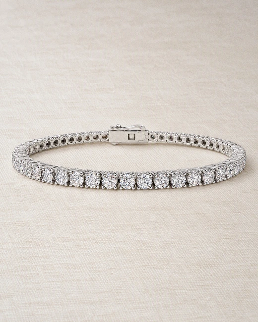 The Classic Tennis Bracelet in a loop on ivory silk