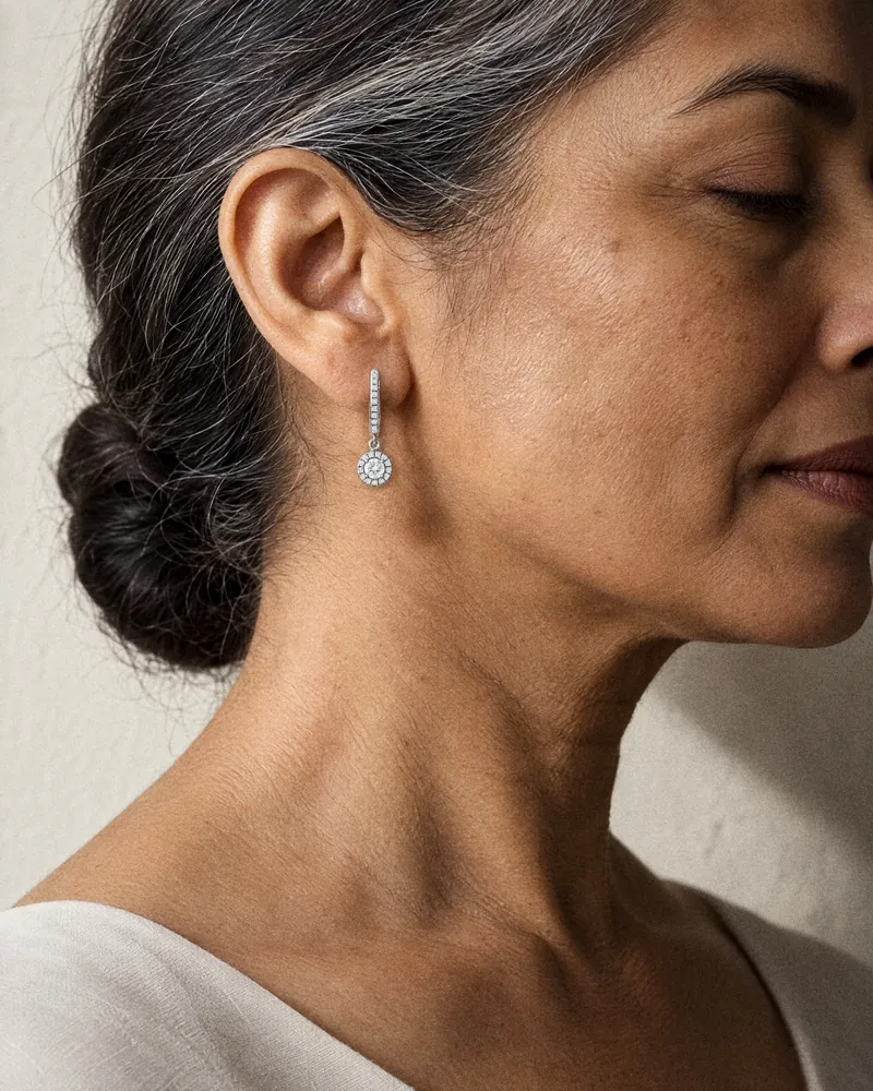 A woman in profile, silver in her hair, wearing a Celeste Drop Earring