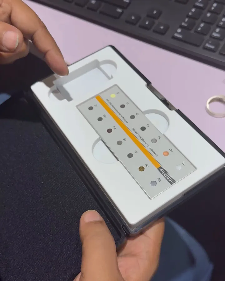 A hand holding the machine’s card of reference standards