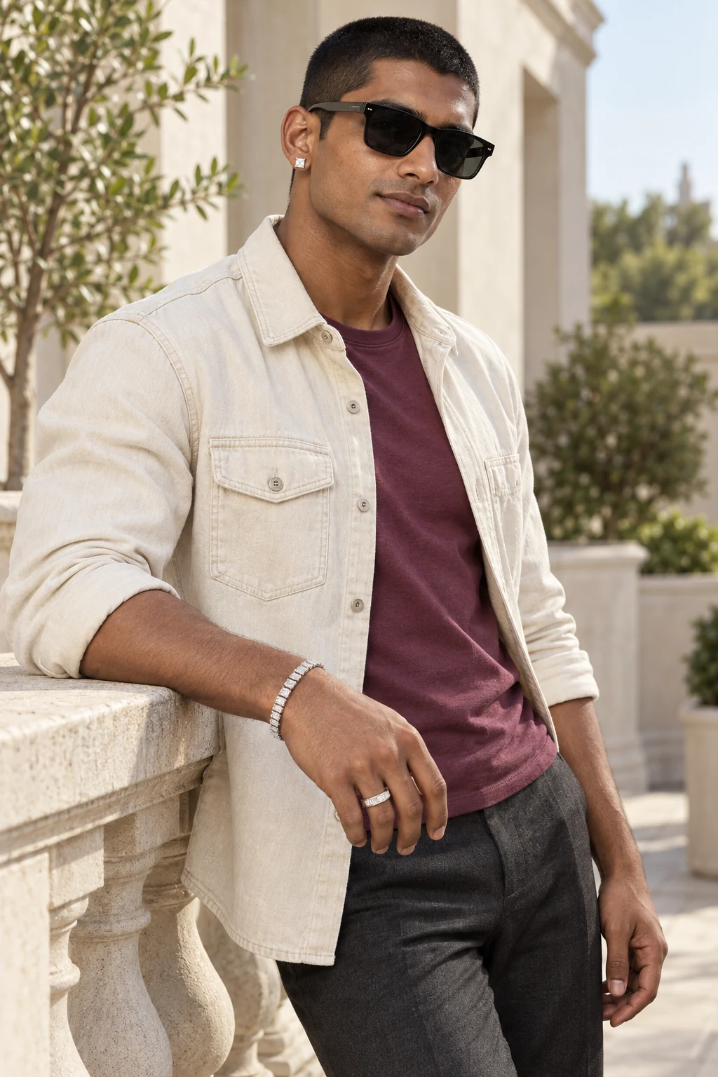 Out of office: An Indian man wearing the Square Eternity Ring, princess-cut Square Stud Earrings and the Emerald-Cut Tennis Bracelet together